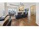 Open living room features hardwood floors, a stone fireplace, modern seating and sliding glass doors at 5955 Stroup Dr, Noblesville, IN 46062