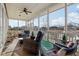 Relaxing screened porch overlooking a serene pond, furnished with comfortable seating and a ceiling fan at 5955 Stroup Dr, Noblesville, IN 46062