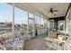 Cozy screened-in porch with scenic water views, offering a tranquil space for relaxation and outdoor enjoyment at 5955 Stroup Dr, Noblesville, IN 46062