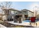 Beautiful backyard with a pool, patio seating, and a charming brick fireplace, ideal for entertaining at 6640 E Deerfield Dr, Zionsville, IN 46077