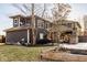 Well-manicured backyard featuring a hot tub, covered patio with fireplace, and lush landscaping at 6640 E Deerfield Dr, Zionsville, IN 46077