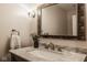 Elegant bathroom vanity featuring marble countertop, modern faucet, and decorative mirror at 6640 E Deerfield Dr, Zionsville, IN 46077