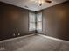 Bedroom featuring neutral carpet, ceiling fan, and a corner window at 6640 E Deerfield Dr, Zionsville, IN 46077