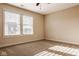 Sun-filled bedroom with neutral carpet, a ceiling fan, and large window with blinds at 6640 E Deerfield Dr, Zionsville, IN 46077