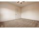 Simple, unfurnished bedroom with carpet, a ceiling fan, and a door at 6640 E Deerfield Dr, Zionsville, IN 46077
