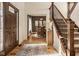 Warm foyer showcasing a wooden staircase, hardwood floors, and access to the dining area at 6640 E Deerfield Dr, Zionsville, IN 46077