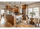 Kitchen features a granite island, a breakfast nook with a round table, and stainless steel appliances at 6640 E Deerfield Dr, Zionsville, IN 46077