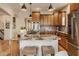 Kitchen with a granite island, a stainless steel oven, and barstool seating, ideal for cooking and entertaining at 6640 E Deerfield Dr, Zionsville, IN 46077