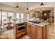 Open-concept kitchen with granite island, stainless steel appliances, and seating flowing into the living area at 6640 E Deerfield Dr, Zionsville, IN 46077