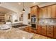 Kitchen features a granite island, gas stovetop, and stainless steel oven, perfect for the home chef at 6640 E Deerfield Dr, Zionsville, IN 46077