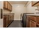 Functional laundry room with cabinets, countertop space, and modern washer/dryer units at 6640 E Deerfield Dr, Zionsville, IN 46077