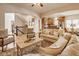 Bright, open-concept living area with hardwood floors, flowing into the kitchen and staircase at 6640 E Deerfield Dr, Zionsville, IN 46077