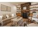 Inviting living room featuring a stone fireplace with built-in shelves and hardwood floors at 6640 E Deerfield Dr, Zionsville, IN 46077