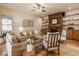 Cozy living room with a stone fireplace, built-in shelving, and hardwood flooring at 6640 E Deerfield Dr, Zionsville, IN 46077