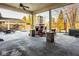 Outdoor patio with fireplace, seating, and view of the pool and backyard at 6640 E Deerfield Dr, Zionsville, IN 46077