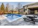 Sparkling pool featuring a brick fireplace and outdoor entertaining space at 6640 E Deerfield Dr, Zionsville, IN 46077