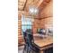 Dining room features a rustic wooden table, carved wood chairs, and light fixture at 6688 Bellsville Pike, Columbus, IN 47201