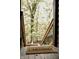 Welcome mat on the wood porch with stairs leading down into nature at 6688 Bellsville Pike, Columbus, IN 47201