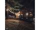 Exterior of a cozy cabin at night, featuring a large deck, and string lights at 6688 Bellsville Pike, Columbus, IN 47201