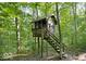 View of a rustic, elevated playhouse in a wooded area with natural light at 6688 Bellsville Pike, Columbus, IN 47201