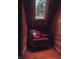 Cozy reading nook with a plush red armchair and a skylight, perfect for relaxing at 6688 Bellsville Pike, Columbus, IN 47201