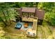 Home with hot tub and outdoor seating, surrounded by trees and well-manicured lawn at 7116 Grandview Rd, Columbus, IN 47201