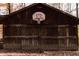 Rustic outdoor barn with a basketball court adds charm and recreational opportunities to the property at 7116 Grandview Rd, Columbus, IN 47201