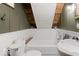 Cozy bathroom featuring white wainscoting, a tub, and a sink, with exposed wooden beams above at 7116 Grandview Rd, Columbus, IN 47201