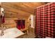Cozy upstairs bathroom features a unique red plaid shower curtain and wood paneled walls at 7116 Grandview Rd, Columbus, IN 47201