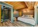 Cozy bedroom with spiral staircase, wood-paneled ceiling, and calming decor at 7116 Grandview Rd, Columbus, IN 47201