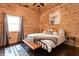 Bedroom featuring a ceiling fan and wood-paneled walls, creating a rustic ambiance at 7116 Grandview Rd, Columbus, IN 47201