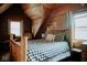 Charming bedroom with wooden walls, a buffalo check bedspread, and natural light from the window at 7116 Grandview Rd, Columbus, IN 47201