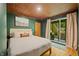 Bedroom features sliding doors to a deck, providing scenic outdoor views and natural light at 7116 Grandview Rd, Columbus, IN 47201