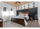 Stylish bedroom with wood accents, a geometric accent wall and lots of natural light at 7116 Grandview Rd, Columbus, IN 47201