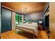 Relaxing bedroom with light-filled window and ensuite door to the private deck at 7116 Grandview Rd, Columbus, IN 47201