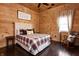 Cozy bedroom with wood walls, ceiling fan, and rocking chair adds comfort at 7116 Grandview Rd, Columbus, IN 47201