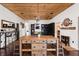Spacious dining area with wood table and views to the fireplace and hallway at 7116 Grandview Rd, Columbus, IN 47201