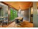 Bright dining room featuring wood ceiling, large windows, and modern lighting fixture at 7116 Grandview Rd, Columbus, IN 47201