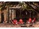 Cozy cabin with red adirondack chairs and a hammock nestled among autumn foliage at 7116 Grandview Rd, Columbus, IN 47201