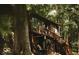 Exterior view of a rustic log cabin surrounded by mature trees and natural landscape at 7116 Grandview Rd, Columbus, IN 47201