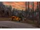 Exterior of home with green roof with sunset in background at 7116 Grandview Rd, Columbus, IN 47201