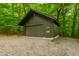 Exterior shot of a garage surrounded by greenery at 7116 Grandview Rd, Columbus, IN 47201