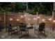 Cozy outdoor fire pit with wooden chairs, surrounded by a privacy fence and ambient string lights at 7116 Grandview Rd, Columbus, IN 47201
