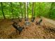 Outdoor firepit area with seating, surrounded by lush trees and natural scenery at 7116 Grandview Rd, Columbus, IN 47201