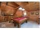 Spacious game room with a pool table, wood-paneled walls, and a cozy, inviting atmosphere at 7116 Grandview Rd, Columbus, IN 47201