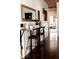 Hallway coffee bar with sleek black barstools, wood countertop, and decorative mirror at 7116 Grandview Rd, Columbus, IN 47201
