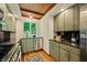 Stylish kitchen with custom cabinets, modern appliances, and view of private wooded setting at 7116 Grandview Rd, Columbus, IN 47201