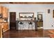 Open kitchen space with custom wood cabinetry, stainless steel appliances, and breakfast bar at 7116 Grandview Rd, Columbus, IN 47201