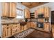 Bright kitchen with wooden cabinets, dark countertops, and stainless steel appliances at 7116 Grandview Rd, Columbus, IN 47201
