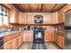 Spacious kitchen featuring wood cabinets, modern appliances, and a stylish black-and-white rug at 7116 Grandview Rd, Columbus, IN 47201